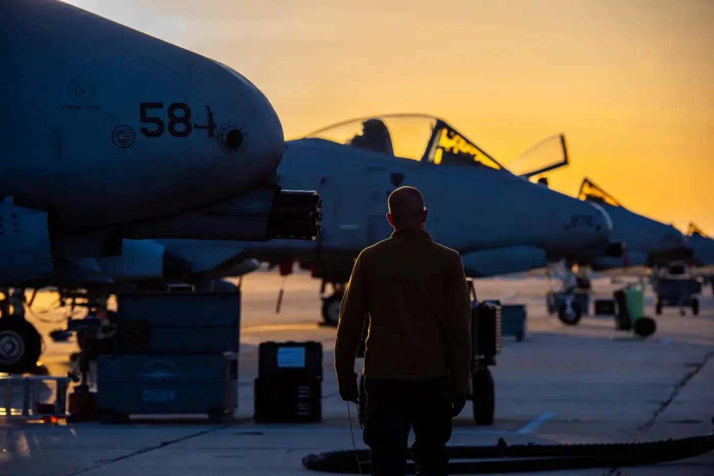 Idaho Air National Guard A-10 Thunderbolt II crew chief silhouetted on the flight line at sunset in Boise, Idaho, photo by Rusty Rehl