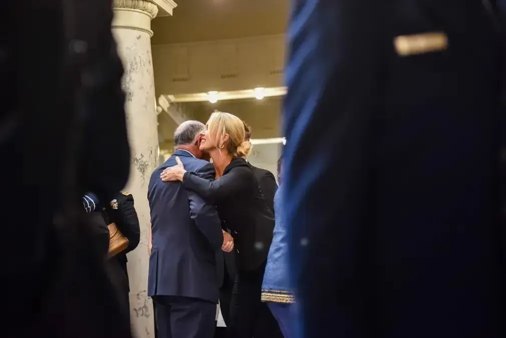Couple embraces after a military ceremony in Idaho, photo by Rusty Rehl