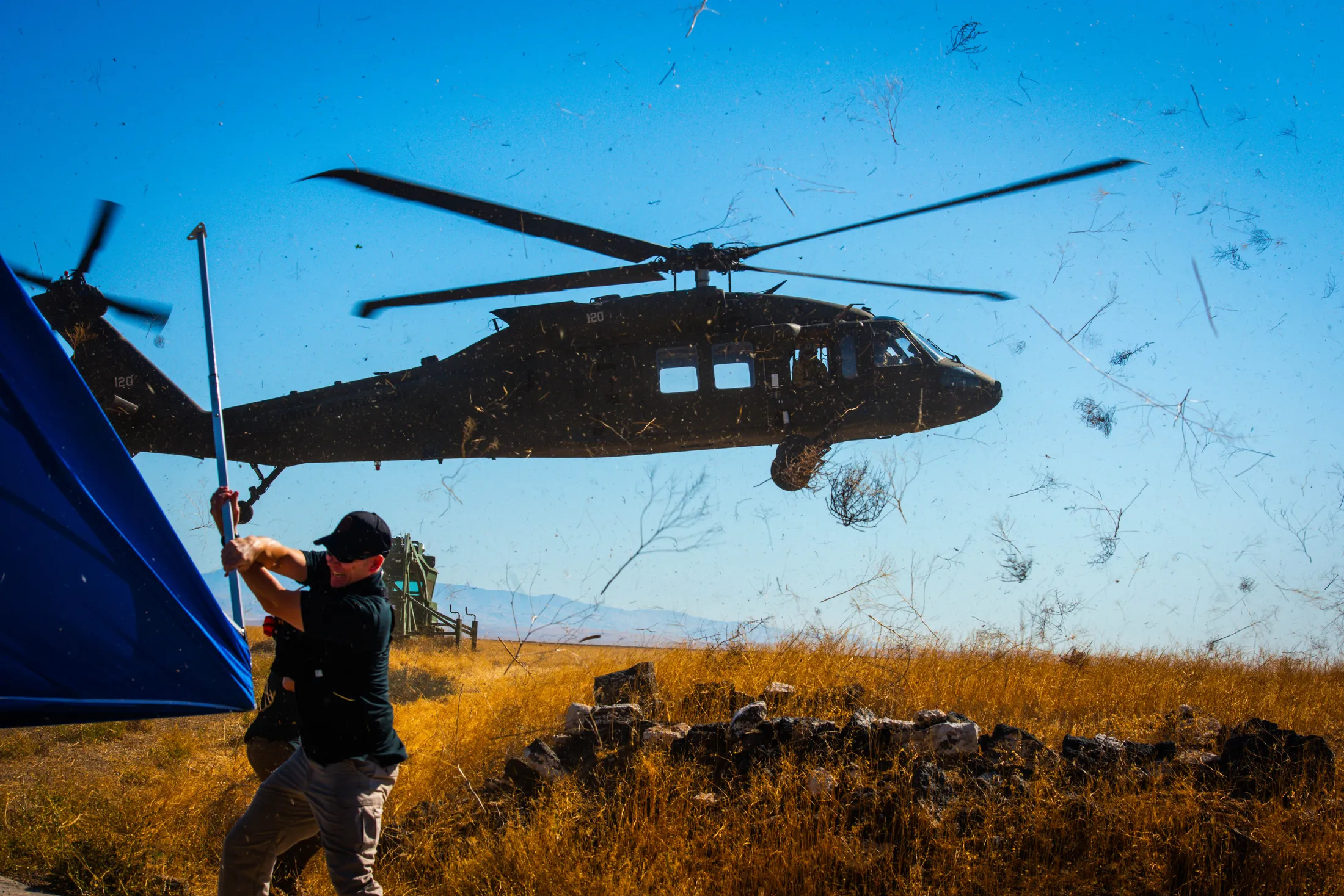 Idaho Army National Guard UH-60 Black Hawk rotor wash throws tumbleweeds across Camp Orchard during Exercise Hellgate, photo by Rusty Rehl