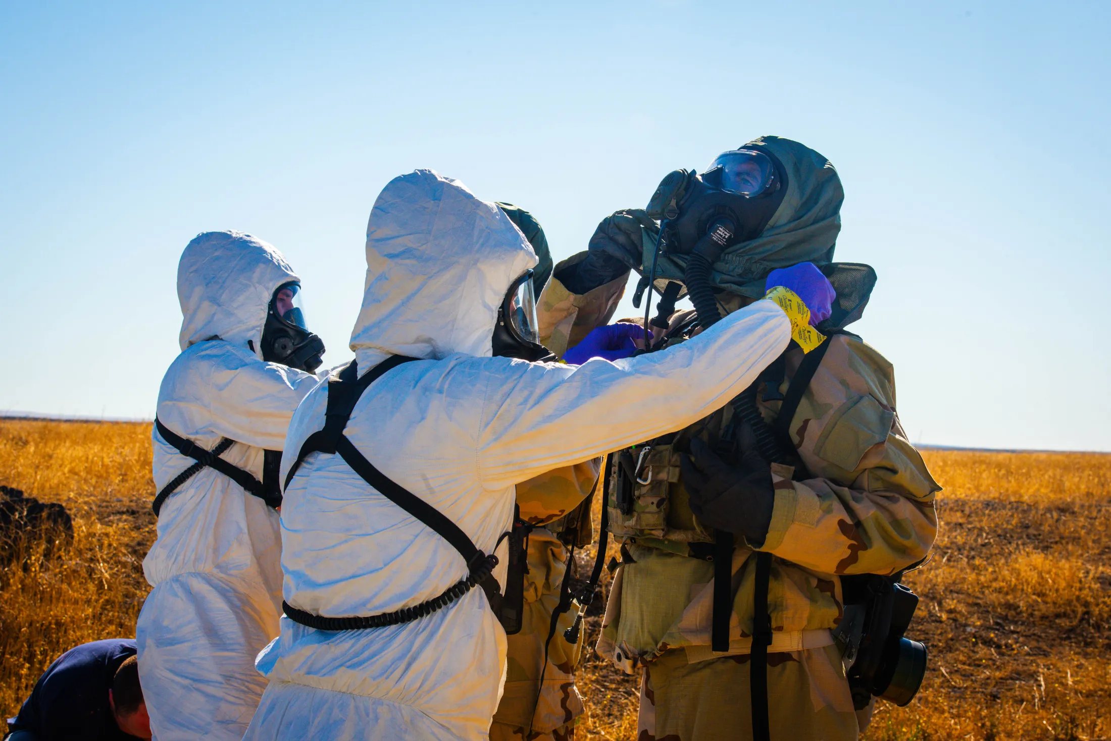 National Guard civil support team members decontaminate a soldier in a protective mask during Exercise Hellgate near Boise, Idaho, photo by Rusty Rehl