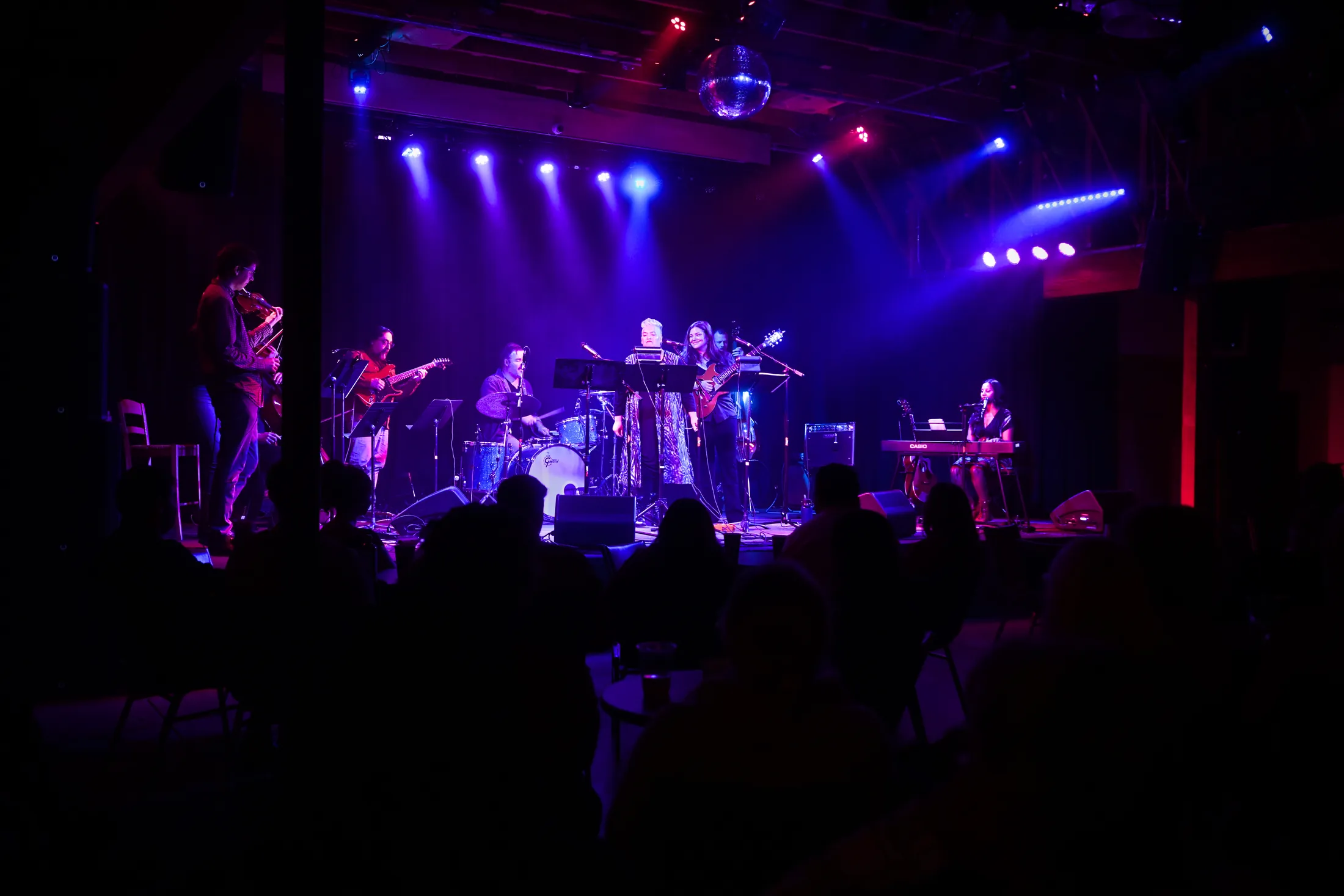 The full room at the Visual Arts Collective from the back of the house, band lit on stage, Garden City, Boise, Idaho concert photo by Rusty Rehl
