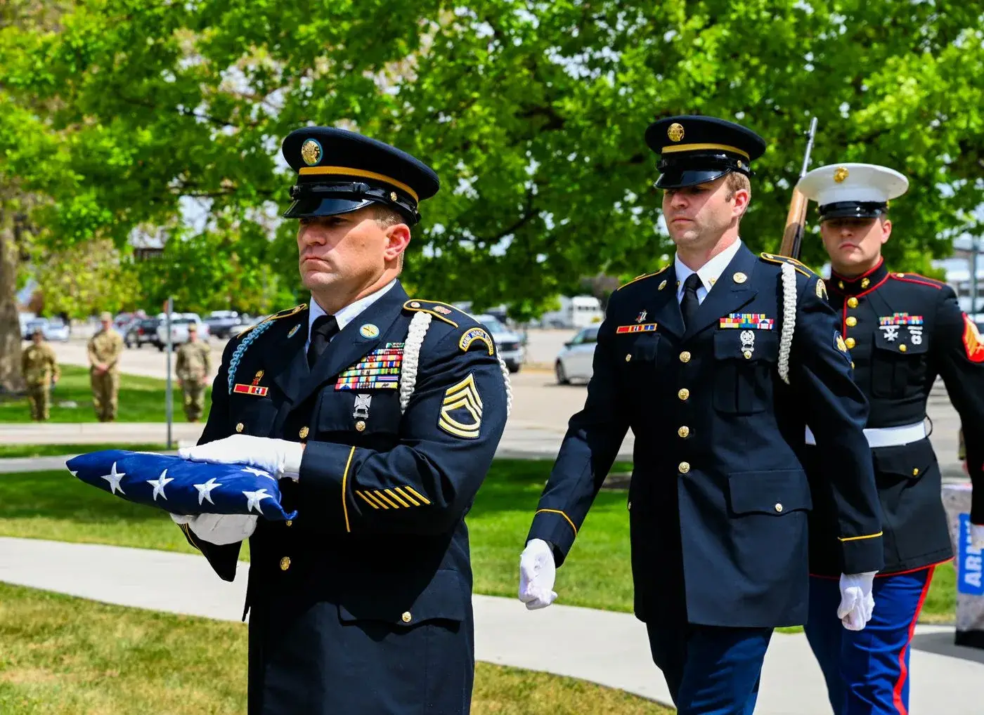 Idaho military funeral honor guard carrying a folded American flag, photo by Rusty Rehl